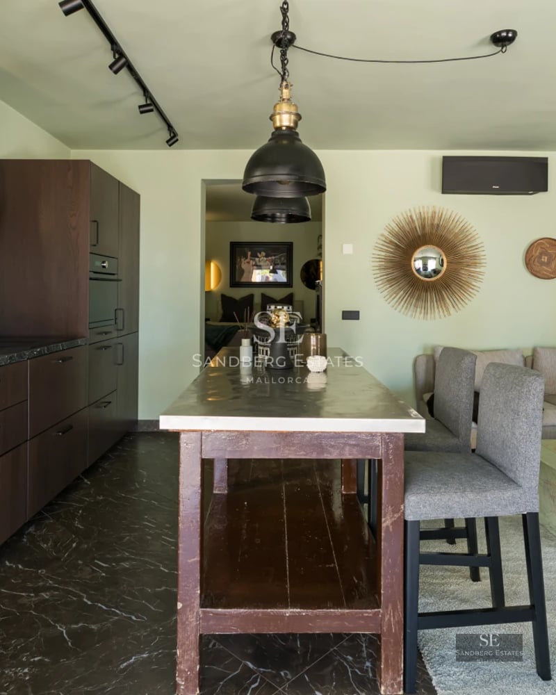 Penthouse terrace featuring an infinity pool, lounge chairs, and stunning sea views. Sleek modern design with high-end materials.