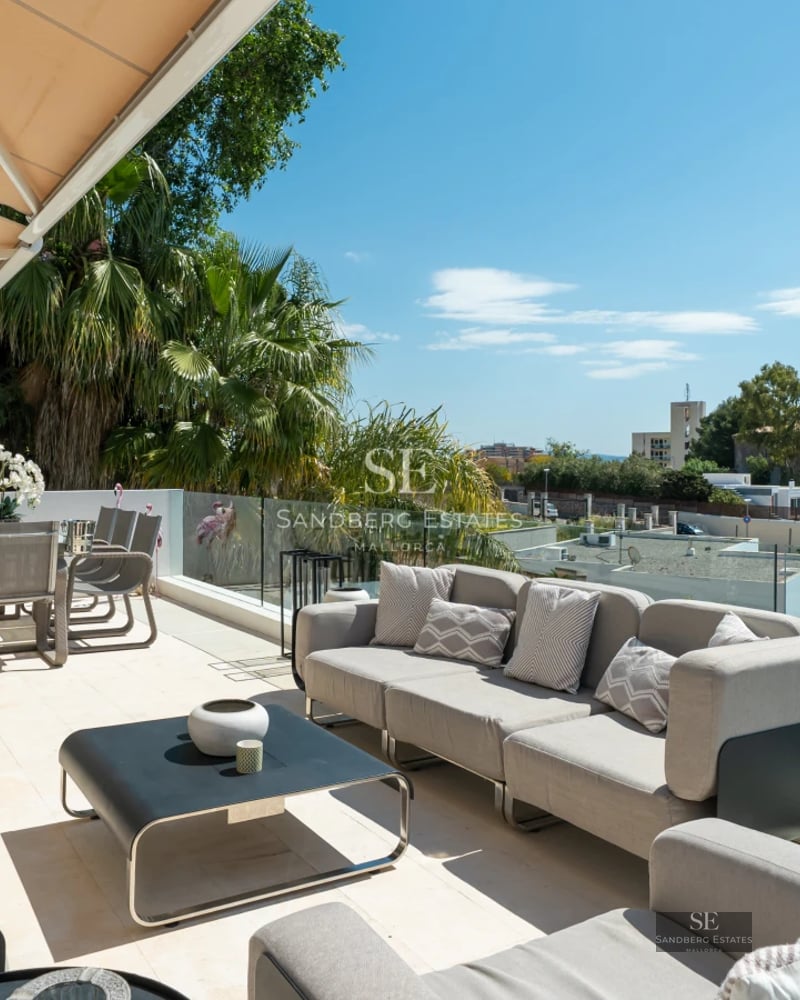 Exterior view of modern house with reflective pool & lush greenery. Minimalist elegant design featuring expansive windows.