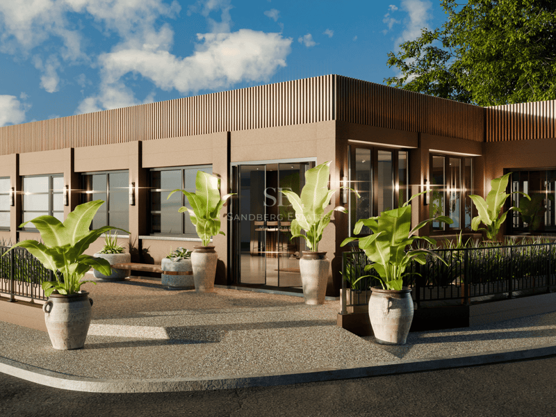 Vue extérieure d'un bâtiment moderne brun avec de grandes fenêtres en verre et des plantes tropicales en pot.