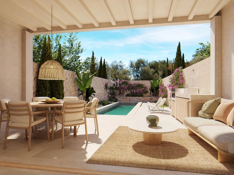 Terrasse couverte avec salle à manger, canapé et cuisine extérieure donnant sur une piscine et un jardin luxuriant.
