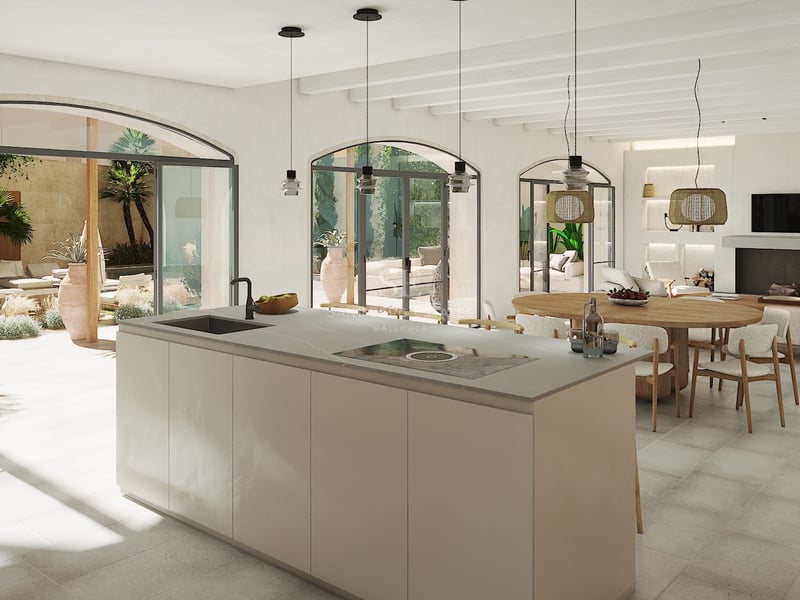 Îlot de cuisine moderne donnant sur la salle à manger et un patio méditerranéen via des portes cintrées.