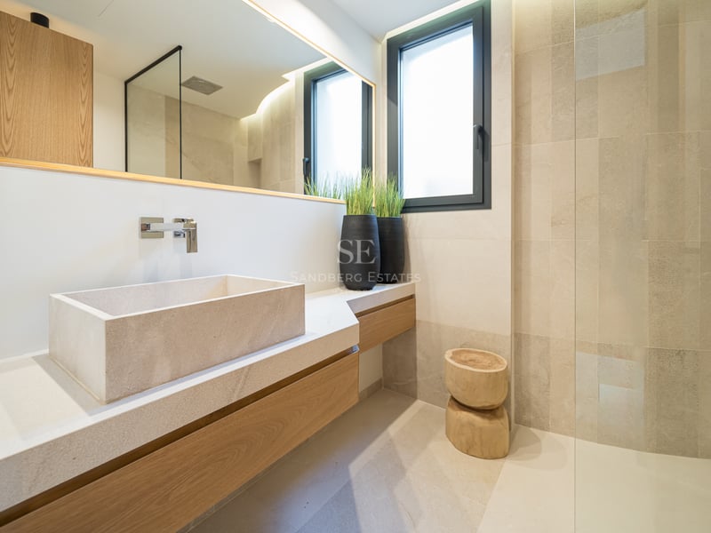 Salle de bain contemporaine avec vasque en pierre, meuble en chêne et douche à l'italienne vitrée.