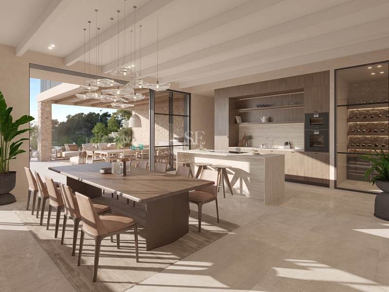 Cuisine contemporaine avec îlot en pierre, table en bois et baies vitrées s'ouvrant sur une terrasse.