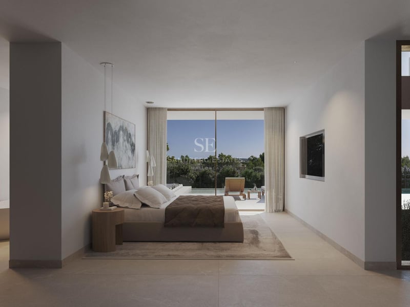 Chambre principale moderne avec baies vitrées ouvrant sur une terrasse avec piscine et végétation.