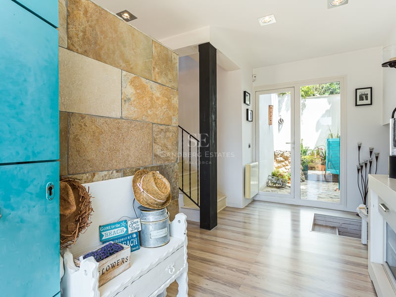 Exterior view of a modern villa with a pool, surrounded by lush greenery and a minimalist architectural design.