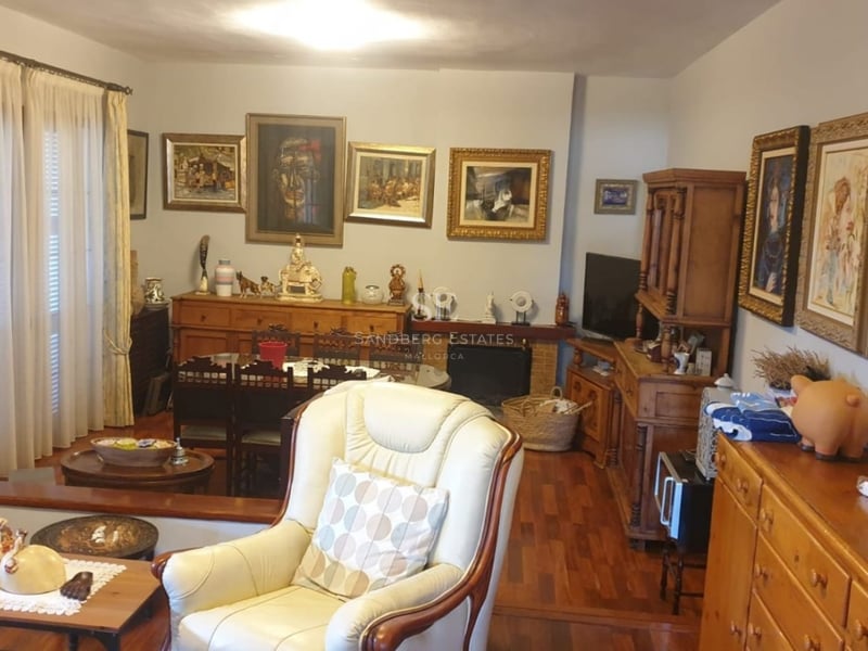 Panoramic view of a luxury villa with an infinity pool, lush garden, and modern architecture. Large terraces and picture windows.