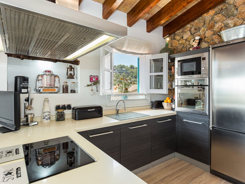 Expansive infinity pool, designer lounge chairs, and modern architecture. Lush garden and panoramic views.