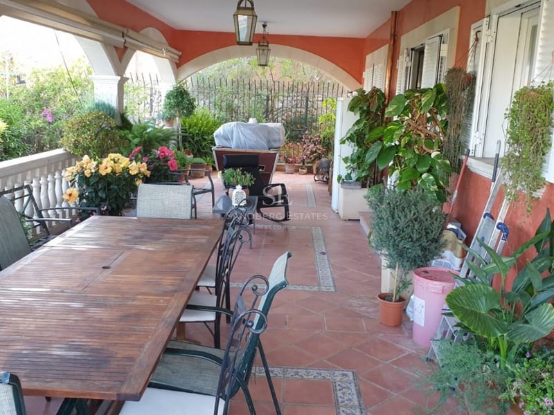 Spacious living room featuring a fireplace, panoramic sea view windows, and modern decor in neutral tones. Designer lamps and high-quality furniture.