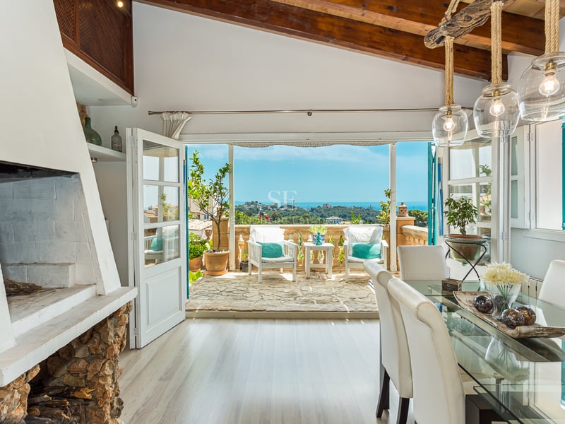 Spacious living room with panoramic windows and sea views. Modern design, elegant furniture and abundant natural light.