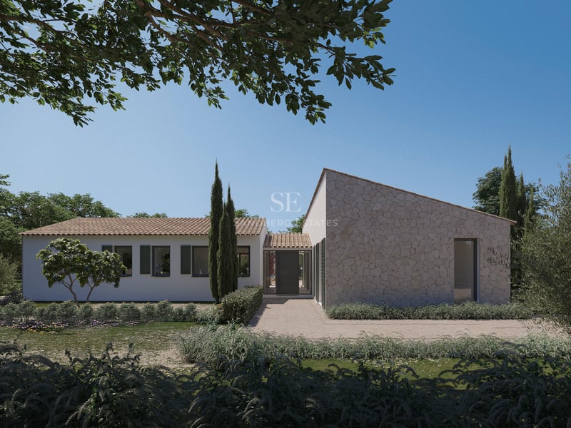 Vue extérieure d'une villa méditerranéenne de luxe avec murs en pierre, enduit blanc et volets verts.