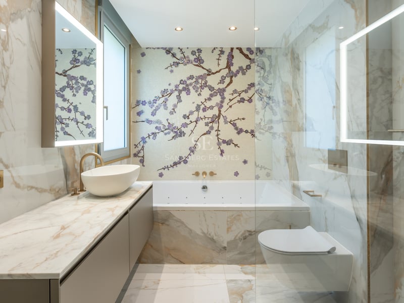 Luxury bathroom featuring Calacatta marble walls, a cherry blossom mosaic feature wall, and backlit LED mirrors.