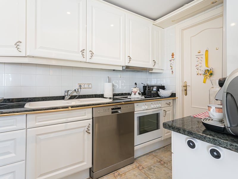 Spacious terrace with pool surrounded by greenery. Modern design, with outdoor furniture and unobstructed views.