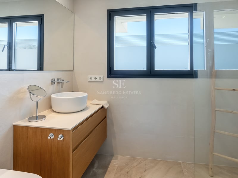 Zeitgenössisches Bad mit weißem Aufsatzwaschbecken auf Eichenunterschrank und Glasdusche.