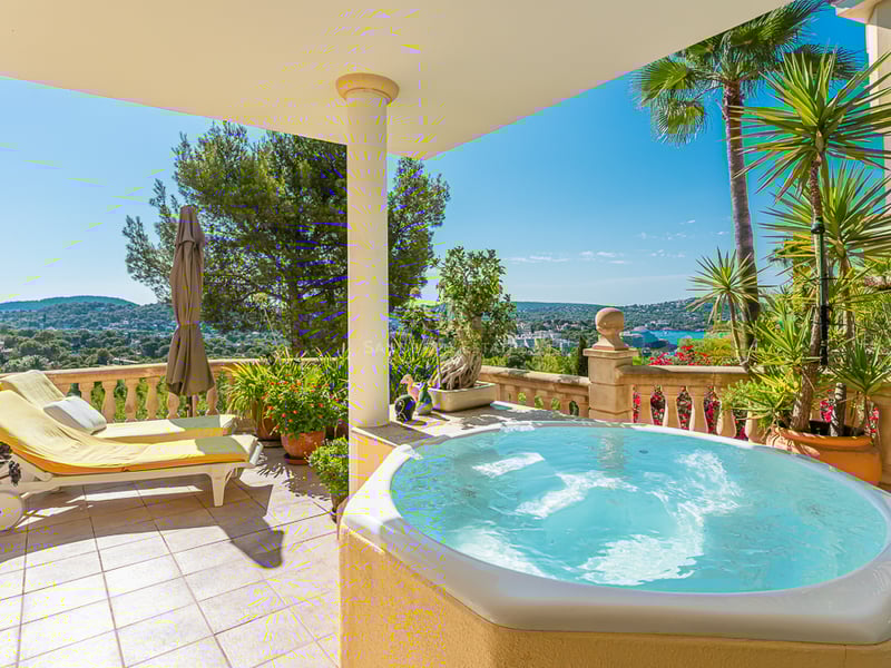 Exterior view of modern villa with infinity pool, lush garden, and expansive terraces. Minimalist architecture and elegant design.