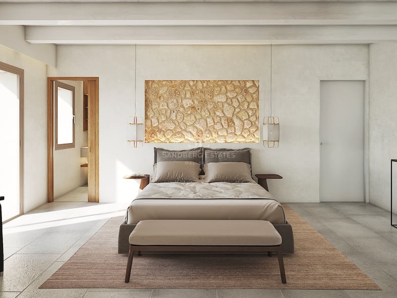 Chambre principale moderne avec mur en pierre naturelle, poutres apparentes et baies vitrées toute hauteur.