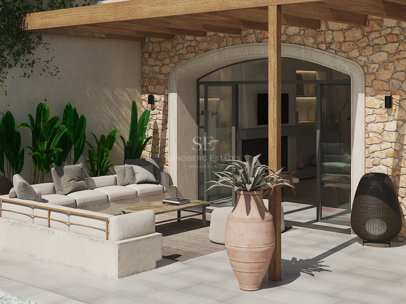 Salon de jardin luxueux avec canapé intégré, pergola en bois et mur en pierre naturelle sous le soleil.