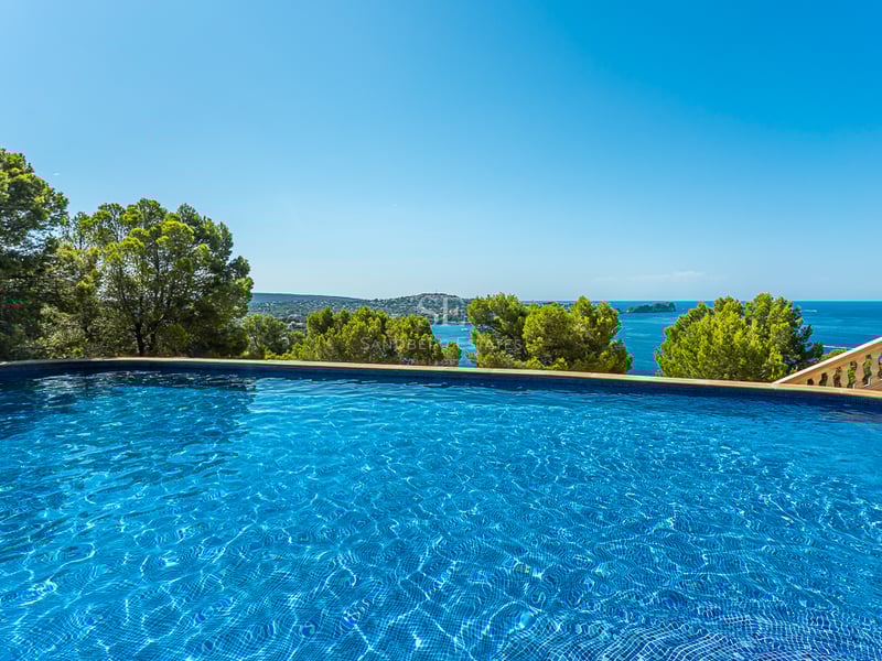 Spacious living room featuring panoramic windows, a modern fireplace, light wood flooring, and stunning views. Natural lighting and designer furniture.