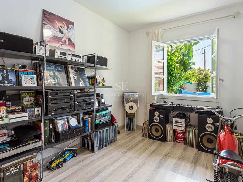 Exterior view of a modern villa featuring an infinity pool, lush garden, and expansive open spaces. Minimalist architectural design.