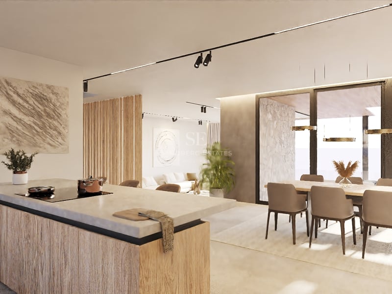 Contemporary open-plan kitchen with a stone island, wood accents, and floor-to-ceiling windows in a luxury villa.