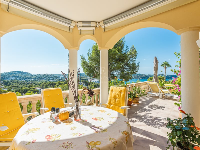 Spacious terrace with infinity pool and sea view. Modern furniture, wood flooring and glass railing. Sleek and minimalist design.