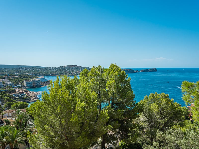 Wide view of a modern balcony with pool and sea view. Minimalist design, abundant natural light, and luxurious finishes.