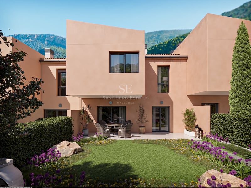 Modern persikofärgad villafasad med geometrisk arkitektur, välskött trädgård med lavendel och bergsutsikt.