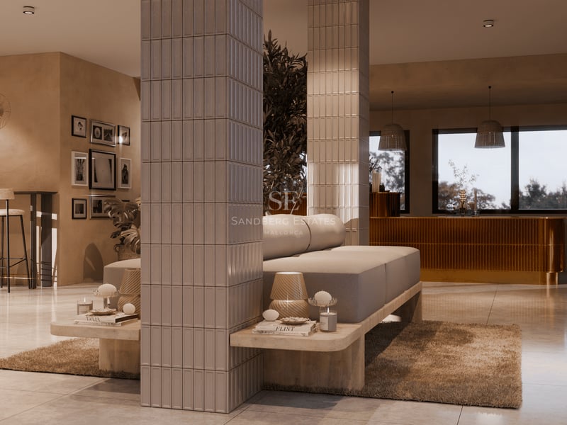 Espace de vie moderne à aire ouverte avec canapés beiges, colonnes carrelées et tons terreux chaleureux.