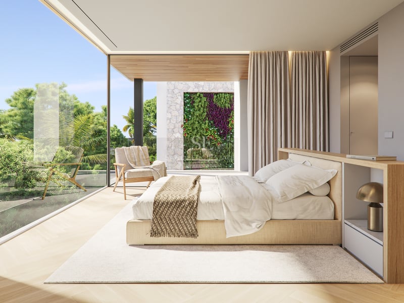 A minimalist master bedroom featuring floor-to-ceiling windows looking out onto a lush green vertical garden.
