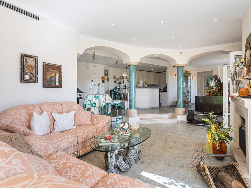 Aerial view of modern villa with infinity pool. Minimalist design, large outdoor spaces, lush gardens, and panoramic views.