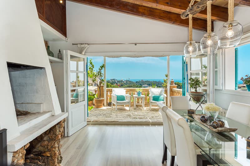 Spacious living room with panoramic windows and sea views. Modern design, elegant furniture and abundant natural light.