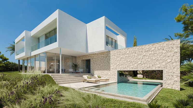 Modern vit villa med naturstensväggar, pool och solstolar under klarblå himmel.