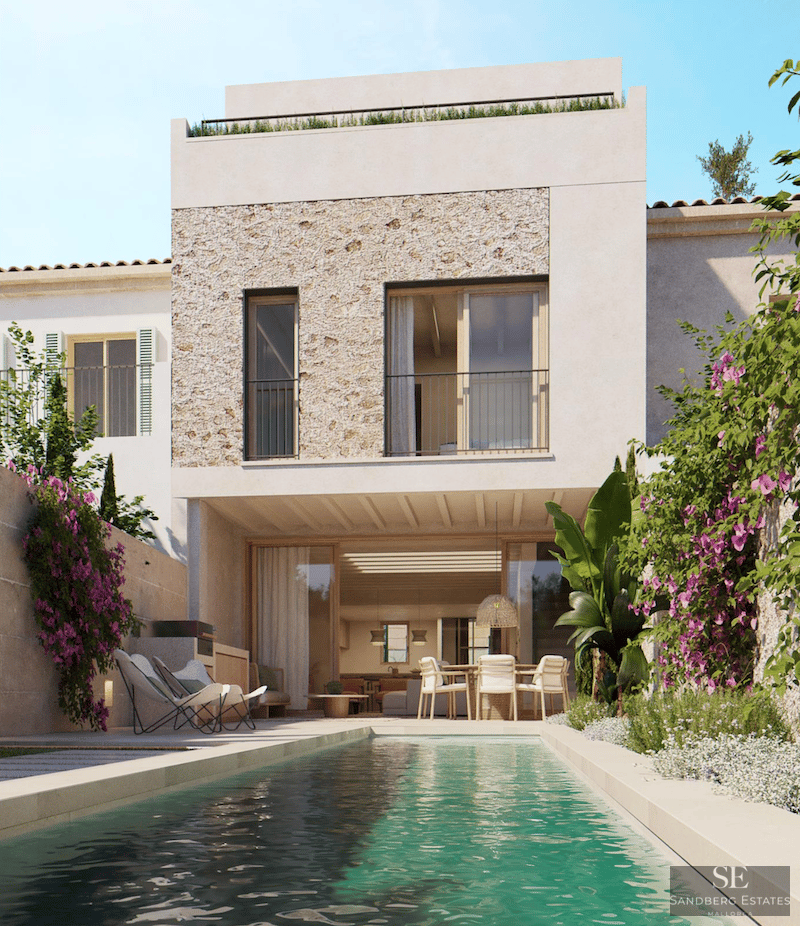 A lap pool in front of a modern white villa with natural stone cladding and vibrant bougainvillea flowers.