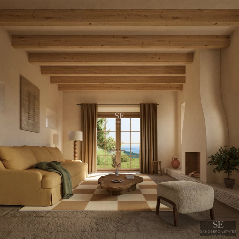 Spacious living room with fireplace, large windows, and sea view. Modern and elegant furniture. Light wood flooring.