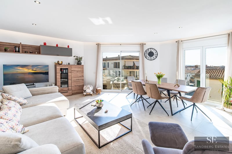 Spacious living room with floor-to-ceiling windows, minimalist furniture, neutral color palette, and access to a terrace with views. Bright and contemporary design.