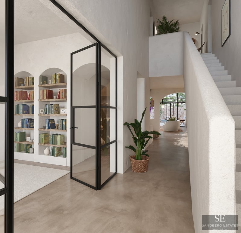 Pasillo luminoso con estanterías integradas en arcos, puertas de cristal con marco negro y escalera blanca.