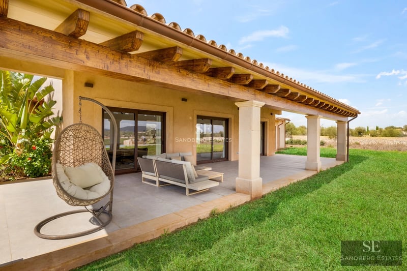 Exterior view of a modern house with a pool, manicured garden, and large windows. Contemporary architecture and landscape design.
