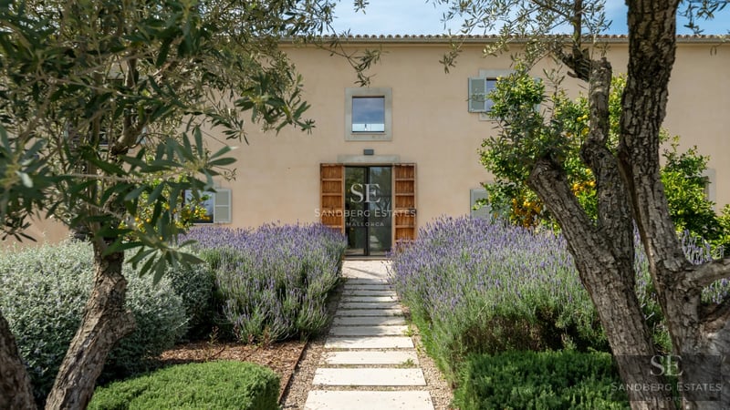 Exterior view of a modern villa with an infinity pool, surrounded by lush gardens and spacious terraces. Minimalist architectural design.