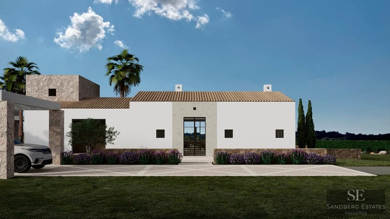 Exterior view of a white modern villa with stone accents, terracotta roof, and lavender bushes under a clear blue sky.