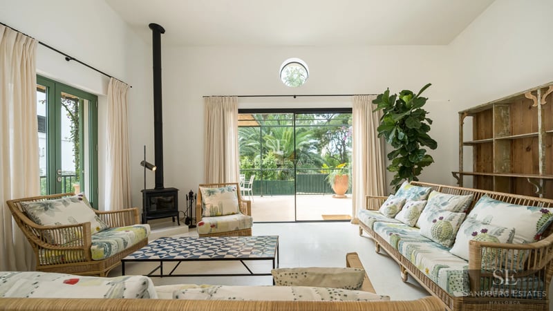 View of an elegant pool surrounded by lush greenery. Modern architecture with large windows and landscaping. Soft lighting.