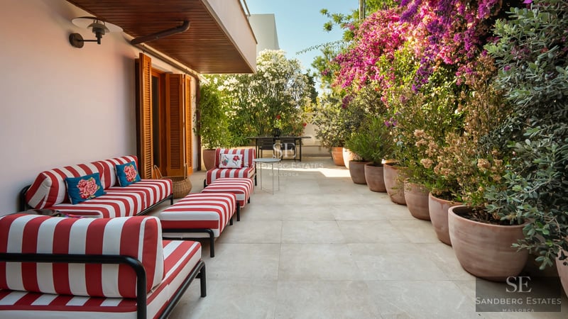 Spacious living room with large windows, modern fireplace and elegant furniture. Panoramic outdoor views.