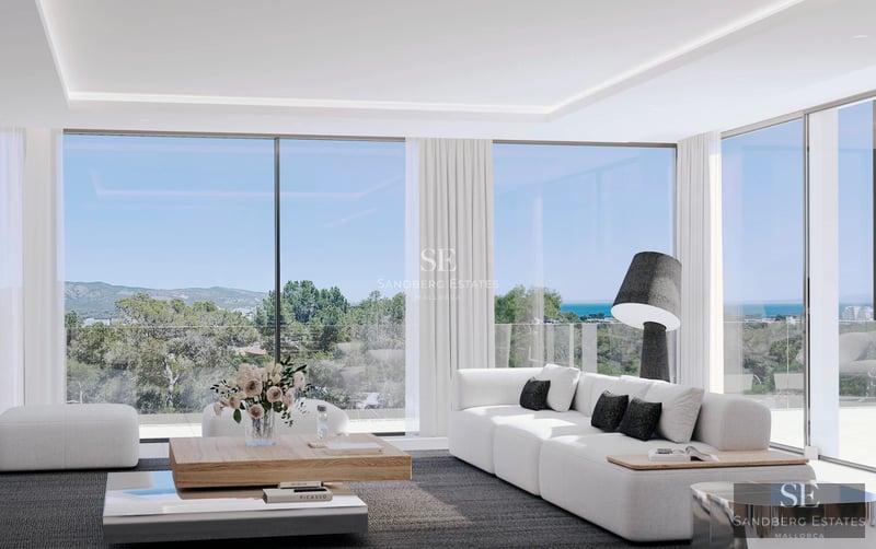 Spacious living room with fireplace, floor-to-ceiling windows, and panoramic views. Modern and elegant interior design.