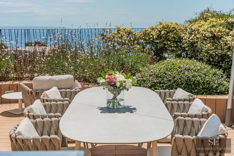 Exterior view of modern villa with reflecting pool. Minimalist architecture, large windows, and lush greenery.