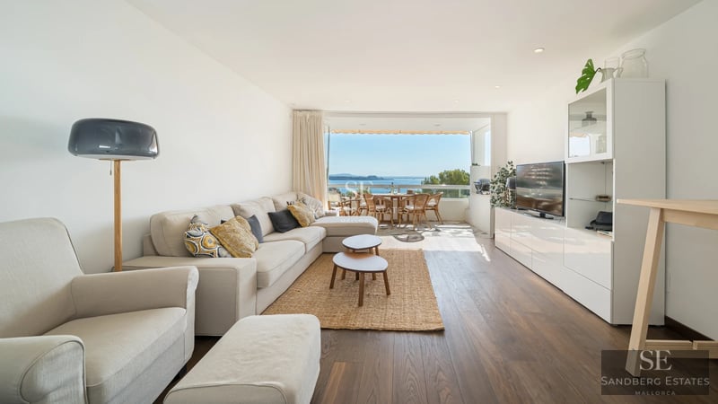 Exterior view of a modern villa featuring an infinity pool, lush garden, and spacious terraces. Minimalist architecture with large windows.