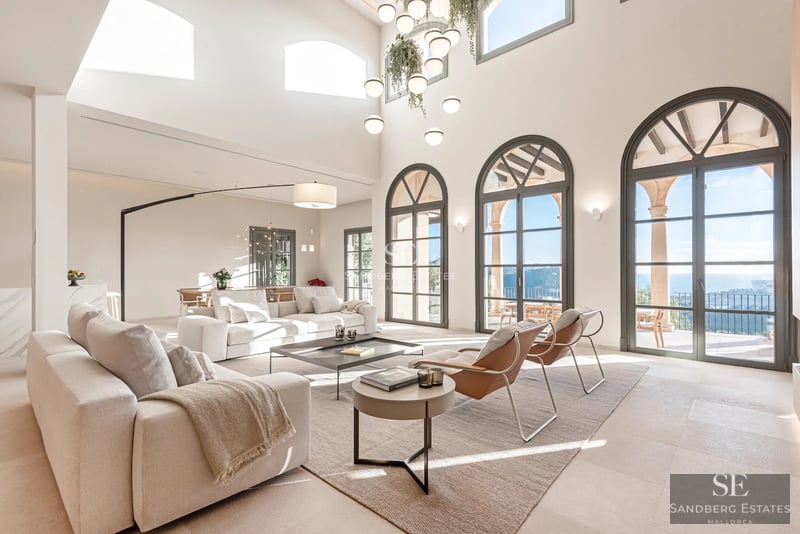 Spacious balcony with sea view. Glass railing, wooden floor, and modern outdoor furniture. Minimalist design with natural light.