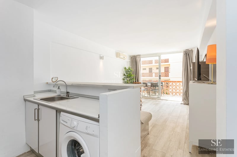 Exterior of a modern villa featuring a pool, large windows, minimalist landscaping, and an elegant terrace. Soft ambient lighting.