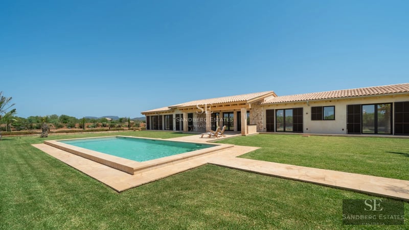 Spacious living room with panoramic sea views. Leather sofas, designer rug, warm lighting, and luxurious details.