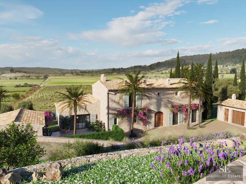 Large rustic stone villa with terracotta roofs, palm trees, and lavender fields under a bright blue sky.