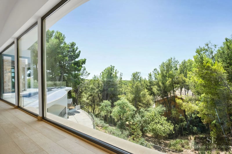 Modern exterior with infinity pool, spacious terraces, and panoramic sea views. Minimalist design featuring large windows.