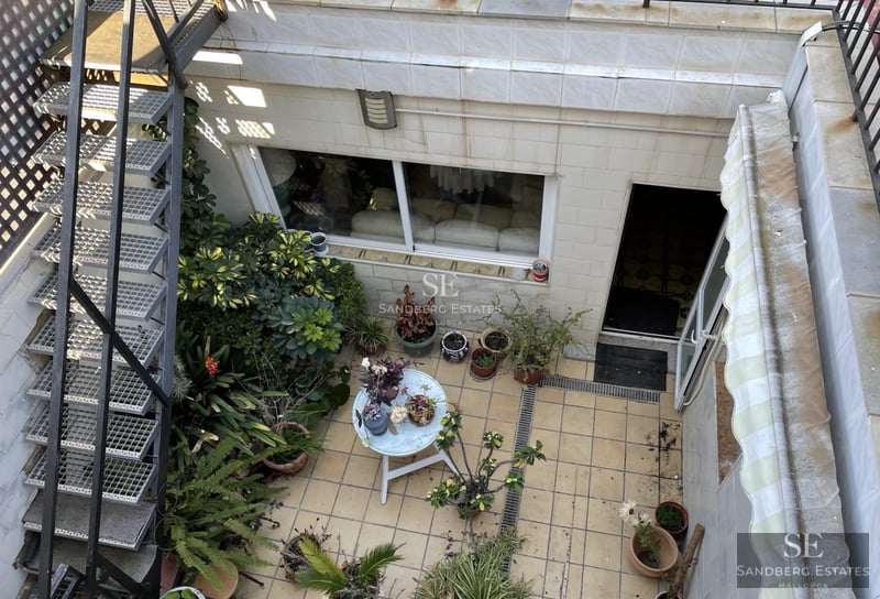 Exterior view of modern villa featuring an infinity pool, lush garden, and minimalist architecture. Warm ambient lighting.