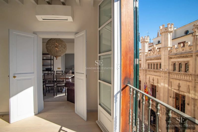 Exterior view of a modern villa with an infinity pool, manicured garden, and minimalist architecture. Warm ambient lighting.